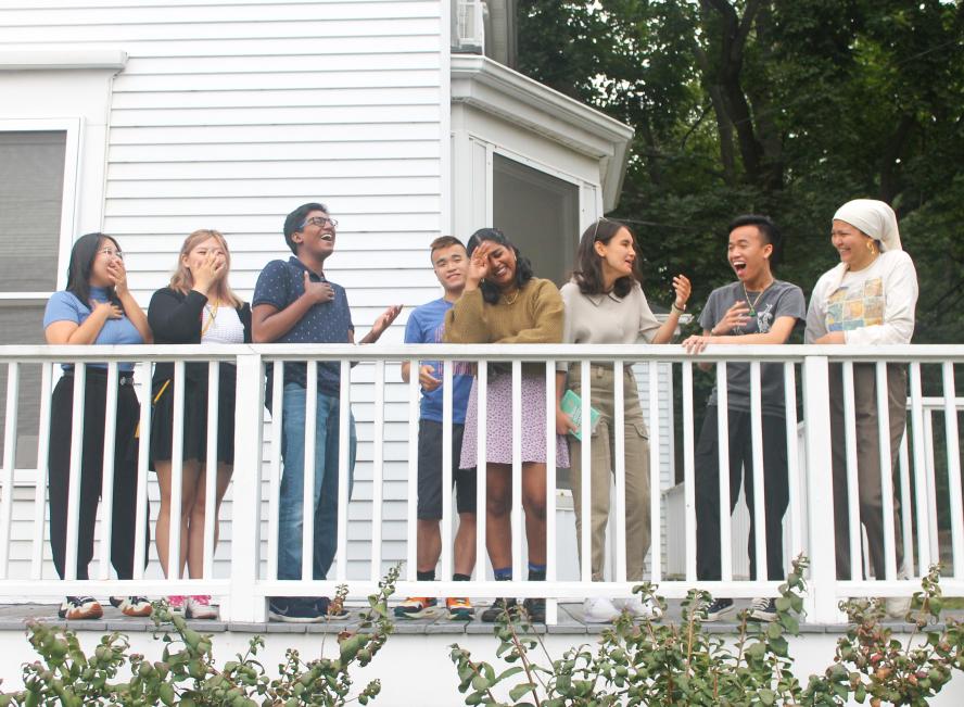 eight students laughing while together on the Asian American Center porch