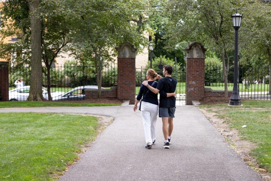 parent and student walking on Tufts campus